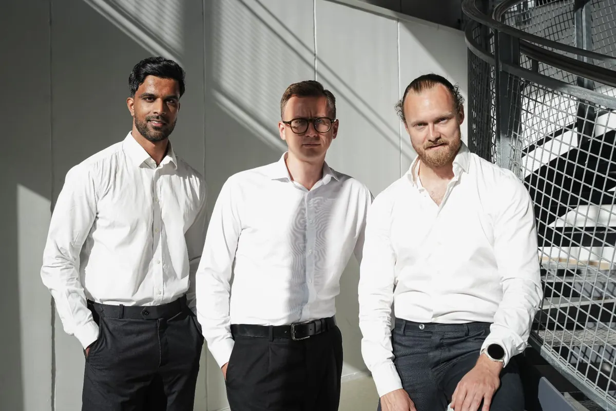 Three Rasch & Co collaborators in a sunlit Oslo office stairwell
